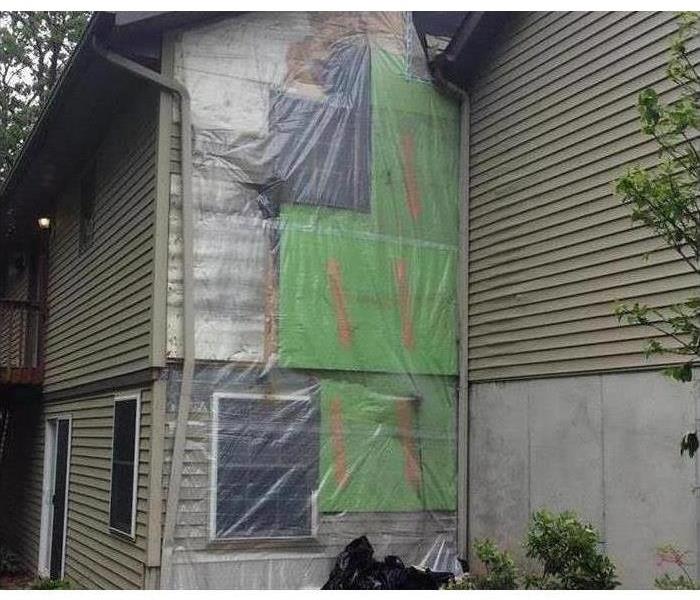 Tarped side of house.
